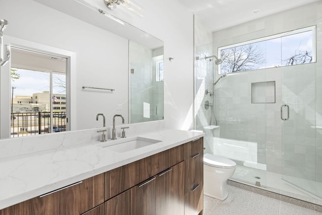 bathroom with a healthy amount of sunlight, a stall shower, toilet, and speckled floor