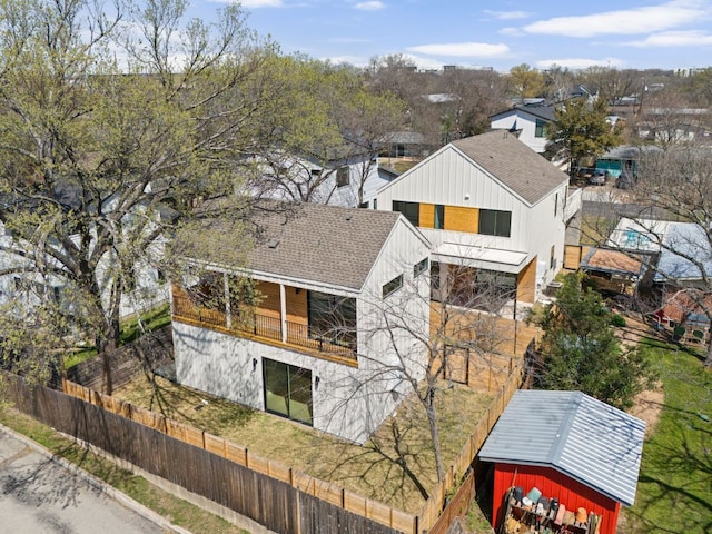 609 Hammack Dr Unit 2, Austin, TX 78752 - view of home's exterior featuring a balcony, a fenced backyard, and roof with shingles