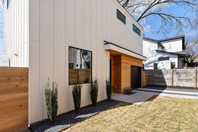 view of home's exterior featuring a garage and fence