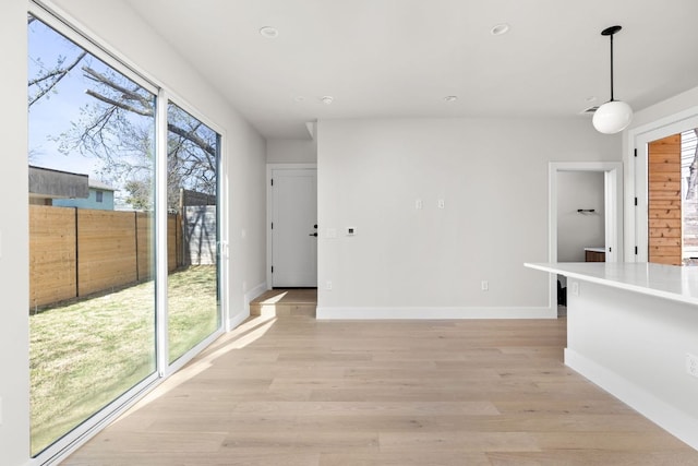 interior space with light wood-style flooring, plenty of natural light, recessed lighting, and baseboards