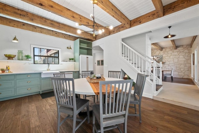 dining room with stairs, beam ceiling, and dark wood-style floors