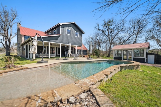 outdoor pool featuring a storage structure, a yard, an outbuilding, and a patio area