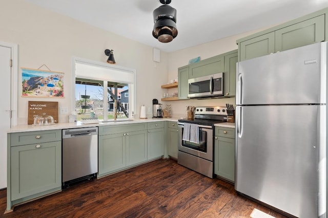 kitchen featuring appliances with stainless steel finishes, light countertops, and green cabinets