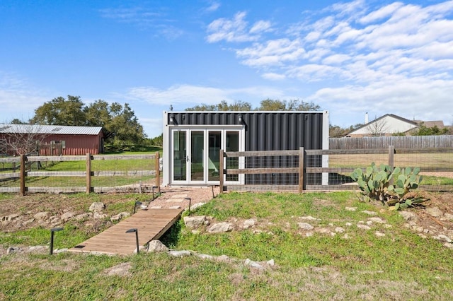 view of outbuilding featuring an outbuilding and fence