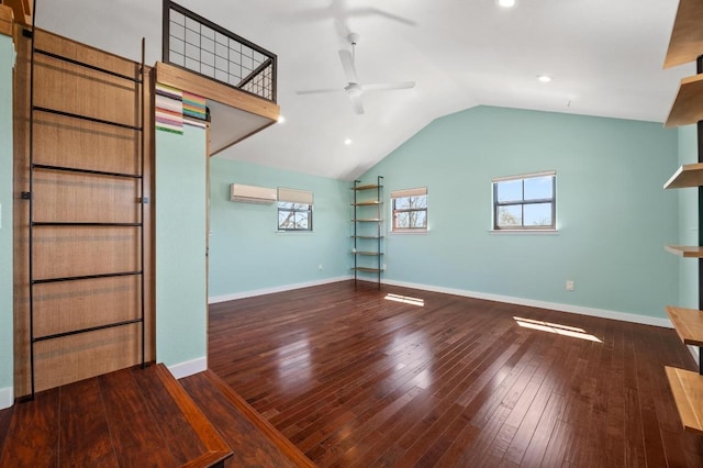 unfurnished living room with baseboards, vaulted ceiling, a wall mounted AC, a ceiling fan, and wood-type flooring