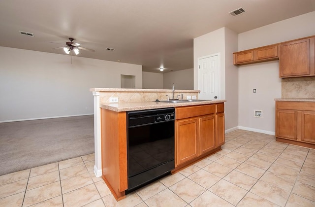 kitchen featuring brown cabinets, black dishwasher, visible vents, and a sink