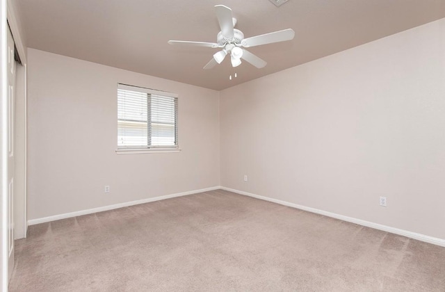 spare room with baseboards, carpet floors, and ceiling fan