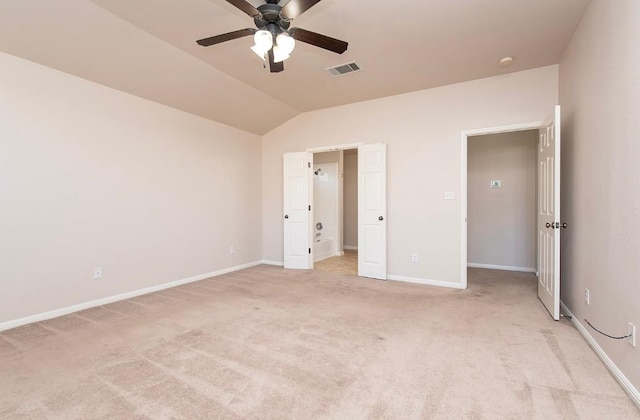 unfurnished bedroom with visible vents, baseboards, light colored carpet, and vaulted ceiling