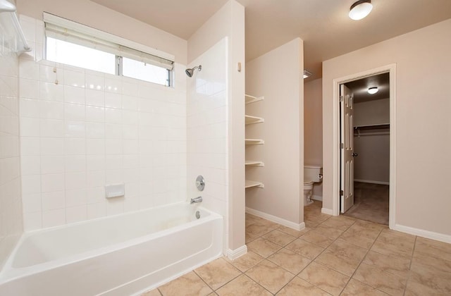 bathroom featuring tile patterned floors, toilet, shower / bath combination, and baseboards