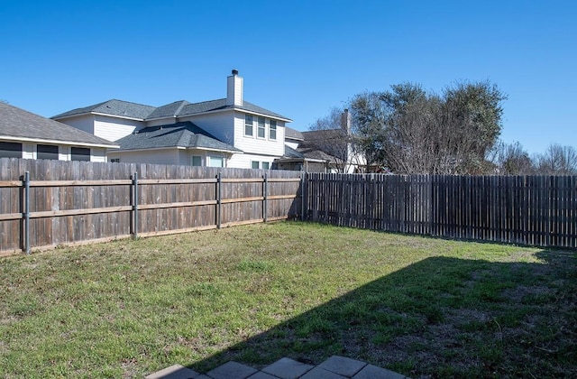 view of yard with a fenced backyard