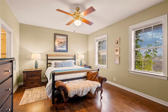 bedroom with baseboards, wood finished floors, and a ceiling fan