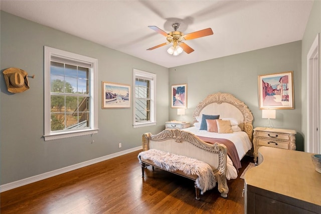 bedroom featuring ceiling fan, baseboards, and wood finished floors