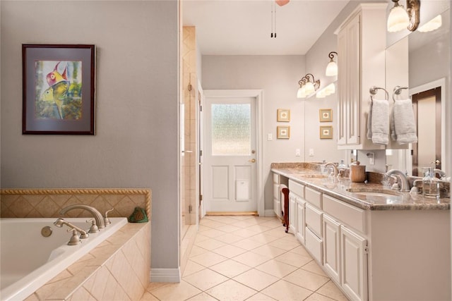 bathroom featuring a sink, a garden tub, double vanity, and tile patterned flooring