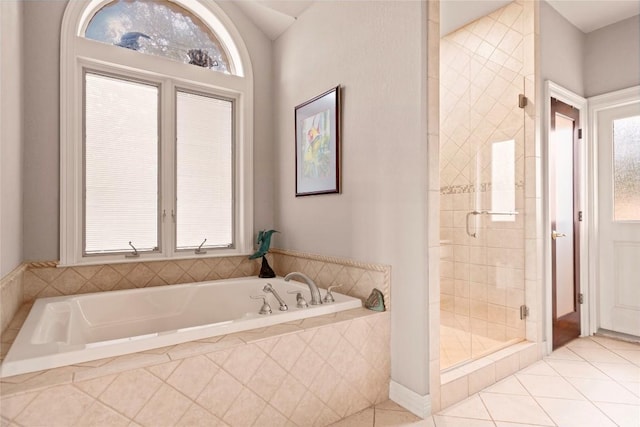 bathroom with a shower stall, a garden tub, and tile patterned floors