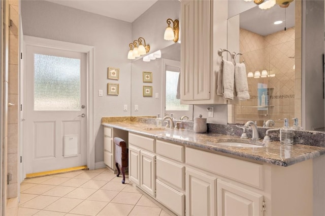 bathroom featuring tile patterned flooring, a shower stall, and a sink