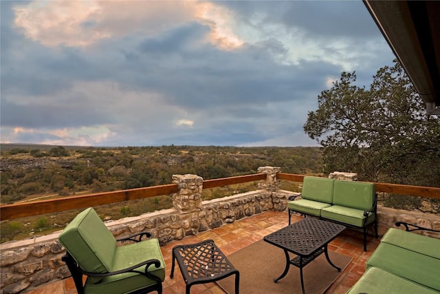 view of patio / terrace featuring an outdoor hangout area and a view of trees