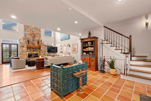 living room featuring stairway, light tile patterned floors, a fireplace, and recessed lighting