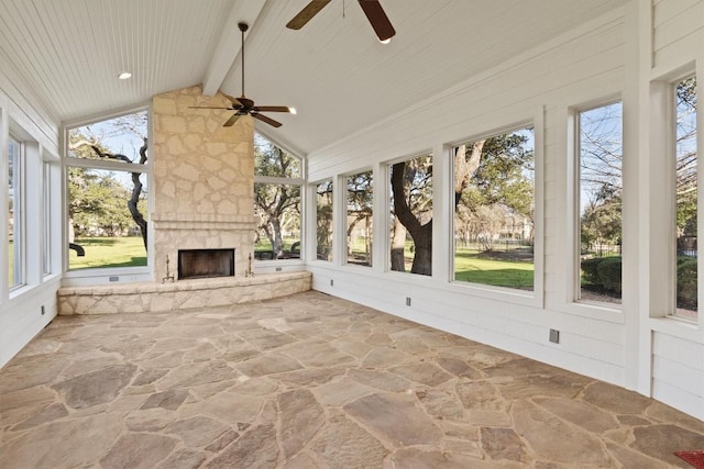 unfurnished sunroom with a fireplace, wooden ceiling, vaulted ceiling with beams, and a ceiling fan