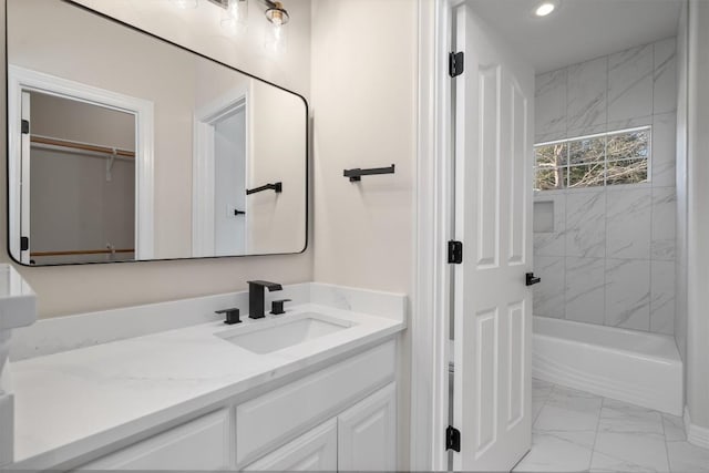 full bathroom featuring vanity, recessed lighting, marble finish floor, and shower / bath combination