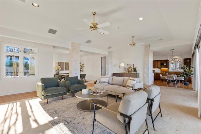 living room featuring visible vents, a ceiling fan, recessed lighting, light wood-style floors, and decorative columns