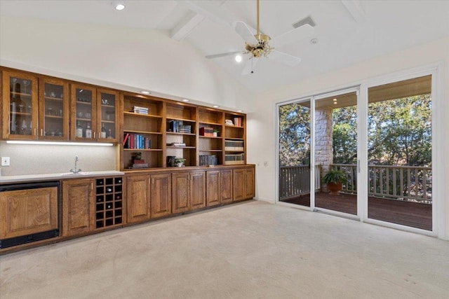 unfurnished office with beam ceiling, high vaulted ceiling, light carpet, and a ceiling fan