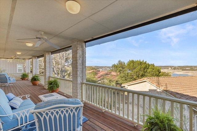 wooden deck featuring a ceiling fan