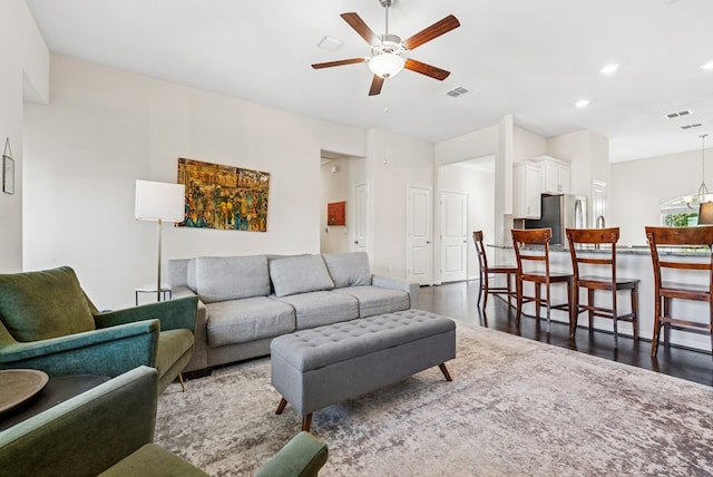 living room featuring visible vents, recessed lighting, a ceiling fan, and dark wood-style flooring