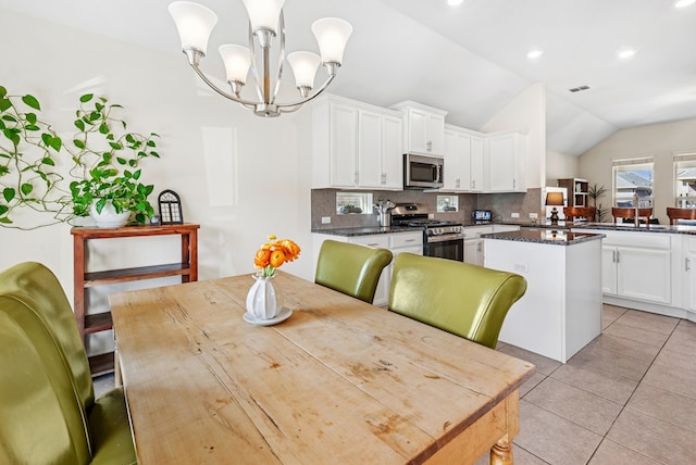 dining space with visible vents, recessed lighting, light tile patterned floors, lofted ceiling, and a chandelier