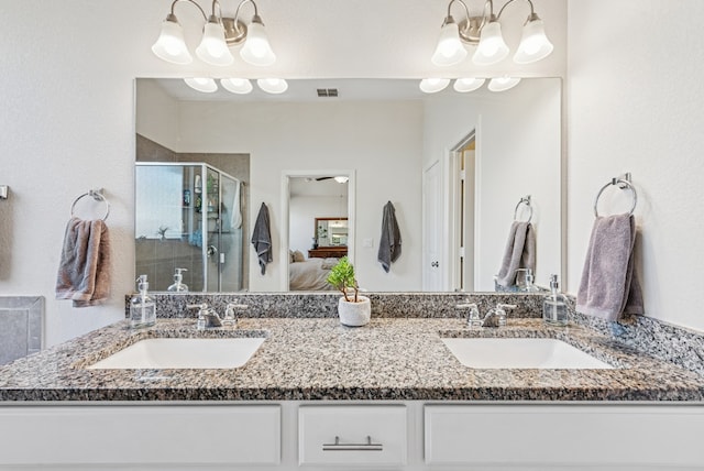 full bath with a sink, visible vents, a stall shower, and connected bathroom