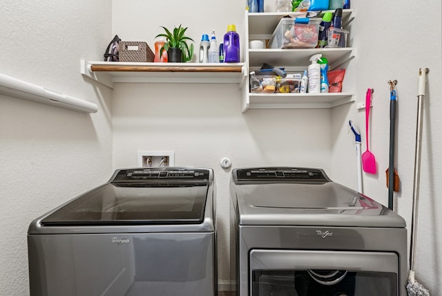 clothes washing area with washer and clothes dryer and laundry area