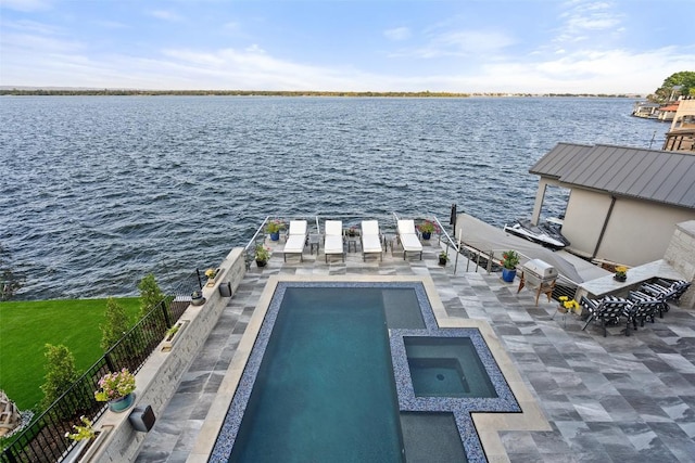 view of swimming pool with a patio area, a pool with connected hot tub, a boat dock, and a water view