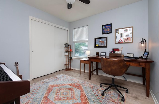 office area featuring baseboards, a ceiling fan, and wood finished floors