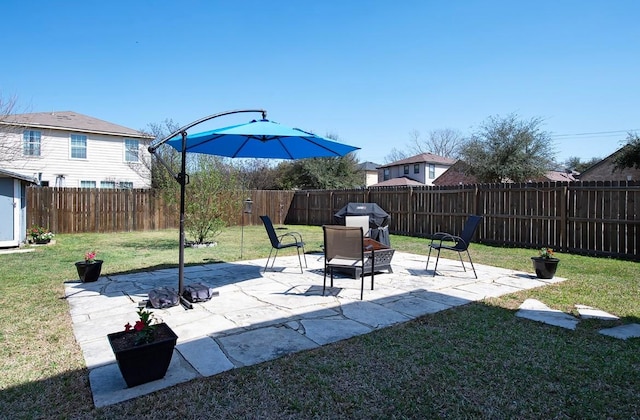 view of yard featuring a patio area and a fenced backyard