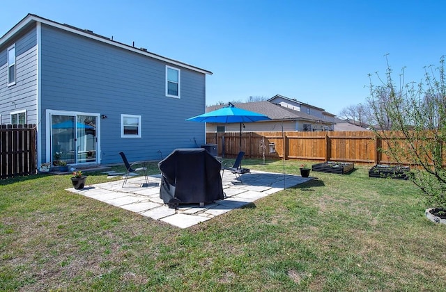 back of house featuring a yard, a vegetable garden, fence private yard, and a patio area