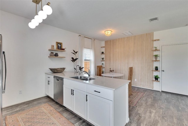 kitchen with open shelves, light wood-style flooring, a peninsula, a sink, and dishwasher