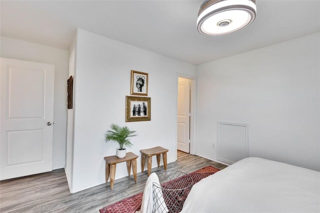 bedroom with baseboards and wood finished floors