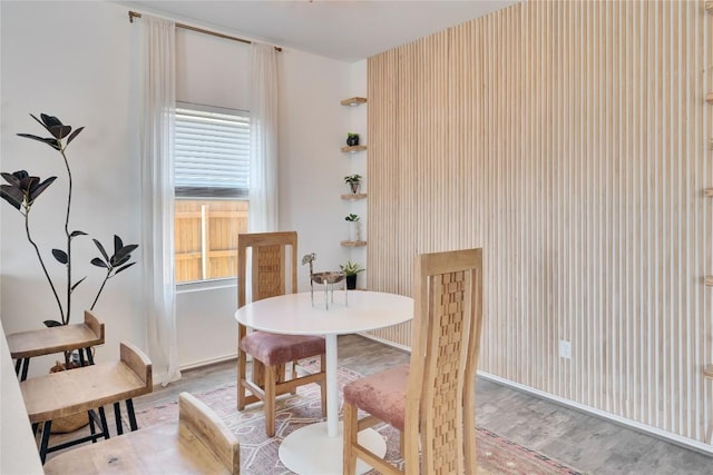 dining space with light wood-style floors and baseboards