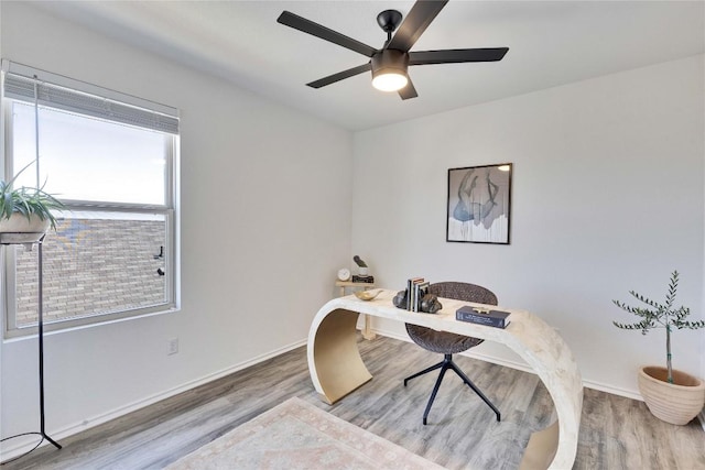 home office with baseboards, wood finished floors, and a ceiling fan