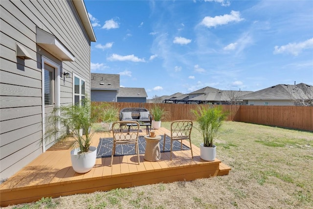 wooden deck featuring a yard and a fenced backyard