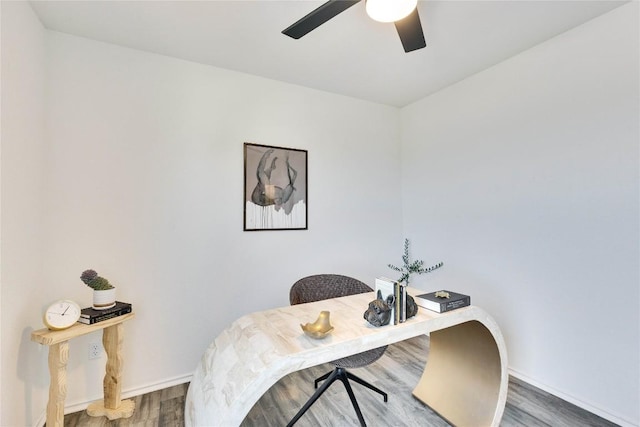 office featuring baseboards, wood finished floors, and a ceiling fan