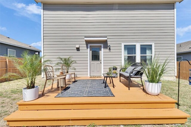 wooden terrace featuring fence