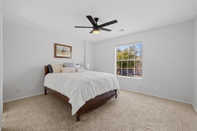 carpeted bedroom featuring baseboards, visible vents, and ceiling fan