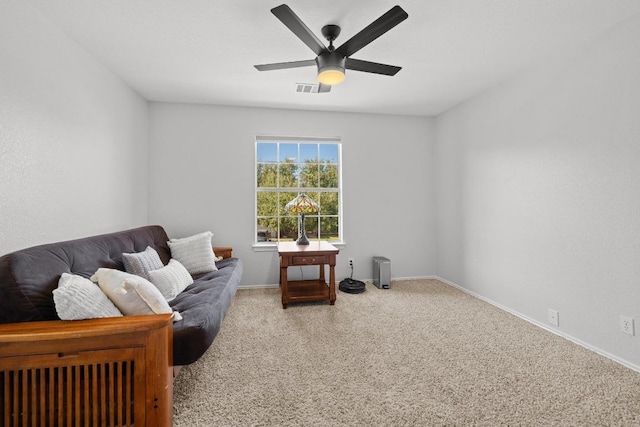 living area with visible vents, carpet flooring, baseboards, and ceiling fan