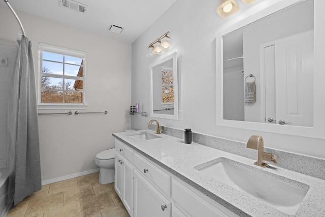 full bath featuring double vanity, toilet, visible vents, and a sink