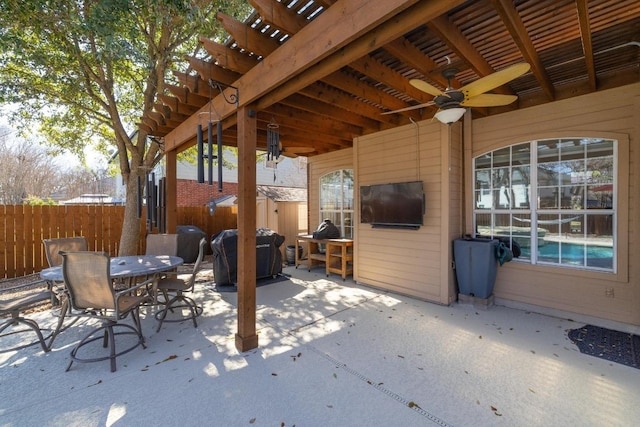 view of patio featuring grilling area, ceiling fan, fence, outdoor dining area, and a pergola