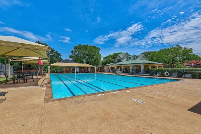 pool featuring a patio area and fence