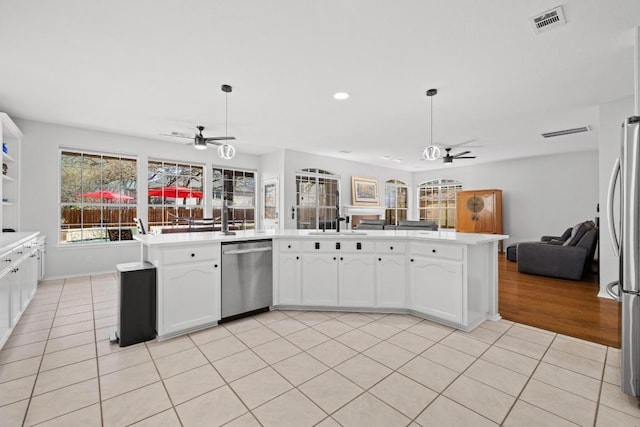 kitchen featuring light tile patterned floors, visible vents, ceiling fan, appliances with stainless steel finishes, and open floor plan