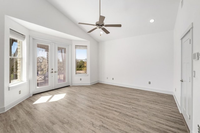 unfurnished room with ceiling fan, french doors, lofted ceiling, and wood finished floors