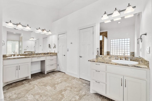 bathroom featuring two vanities and a sink