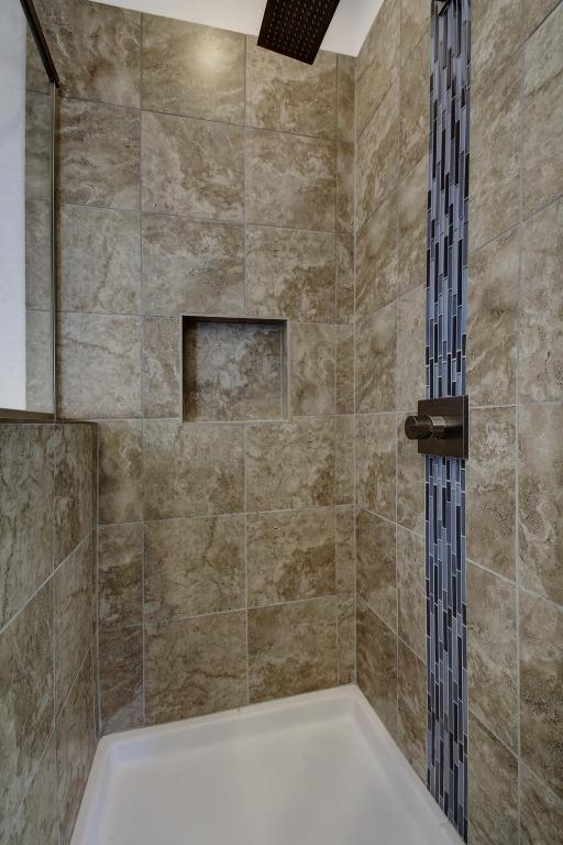 bathroom with tiled shower